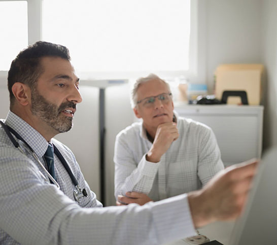 picture of a doctor showing a man some report - DVT